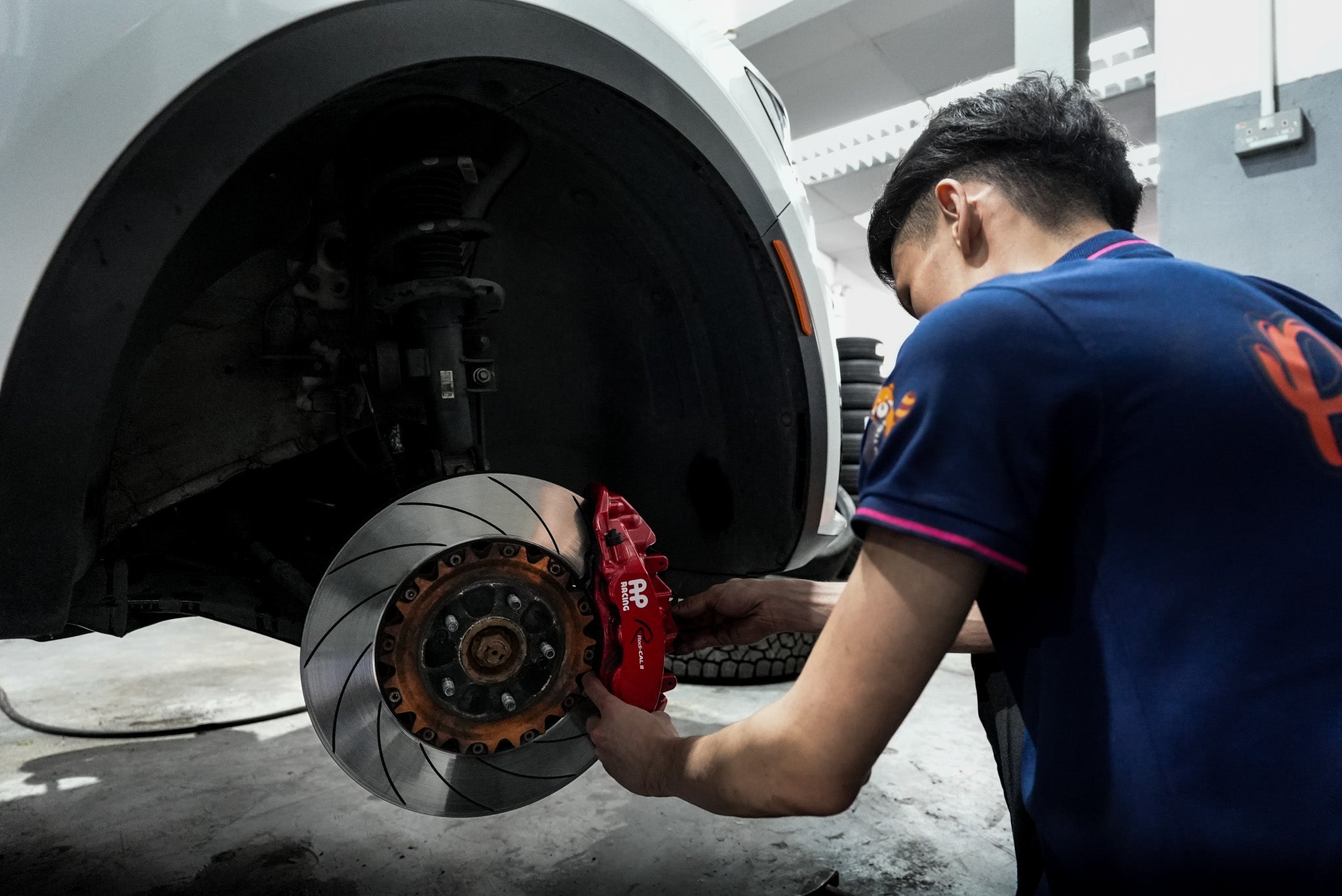 Pitstop Tyres mechanic installing a brake kit, demonstrating professional service and expertise in automotive repairs. 