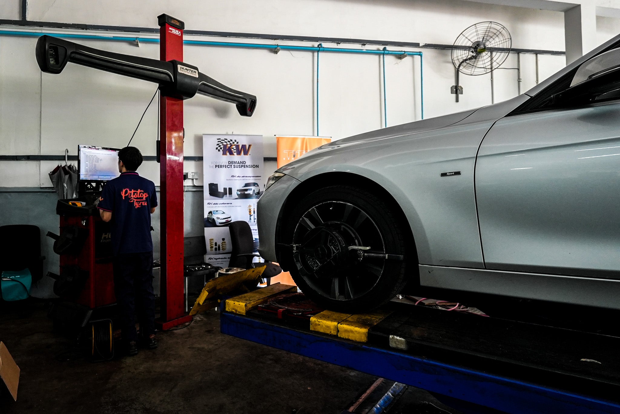 Pitstop Tyres mechanic performing precise wheel alignment, highlighting our professional alignment services to enhance vehicle handling and safety. 